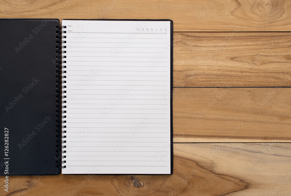 Open notebook on a wooden table backbround with copy space. Open notebook on a wooden table backbround with copy space.