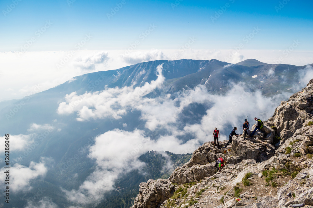 OLYMPUS NATIONAL PARK, GREECE - JULY 11, 2015: Tourists climbing the Olympus mountain in Greece.