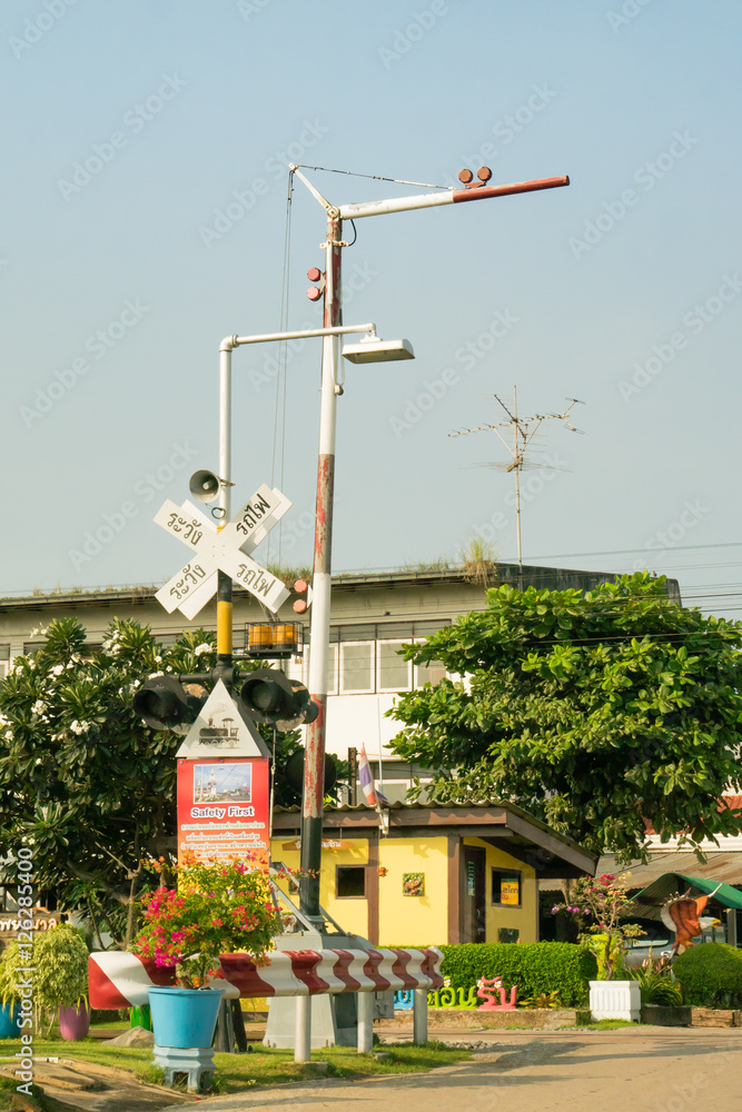 Crossing gate sign with electric poles, warning in Thai train railway , message 