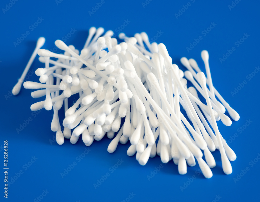 Cotton buds lie hill on blue background Cotton buds lie hill on blue background