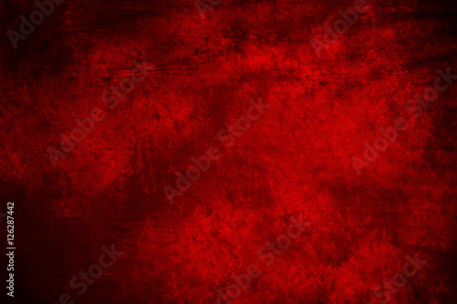 red fabric artistic background with simulated blurred ink. © Parfenova