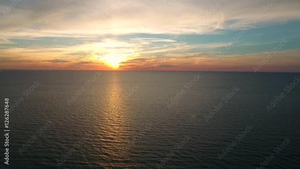 Aerial shot of beautiful ocean sunset above calm sea Aerial shot of beautiful ocean sunset above calm sea