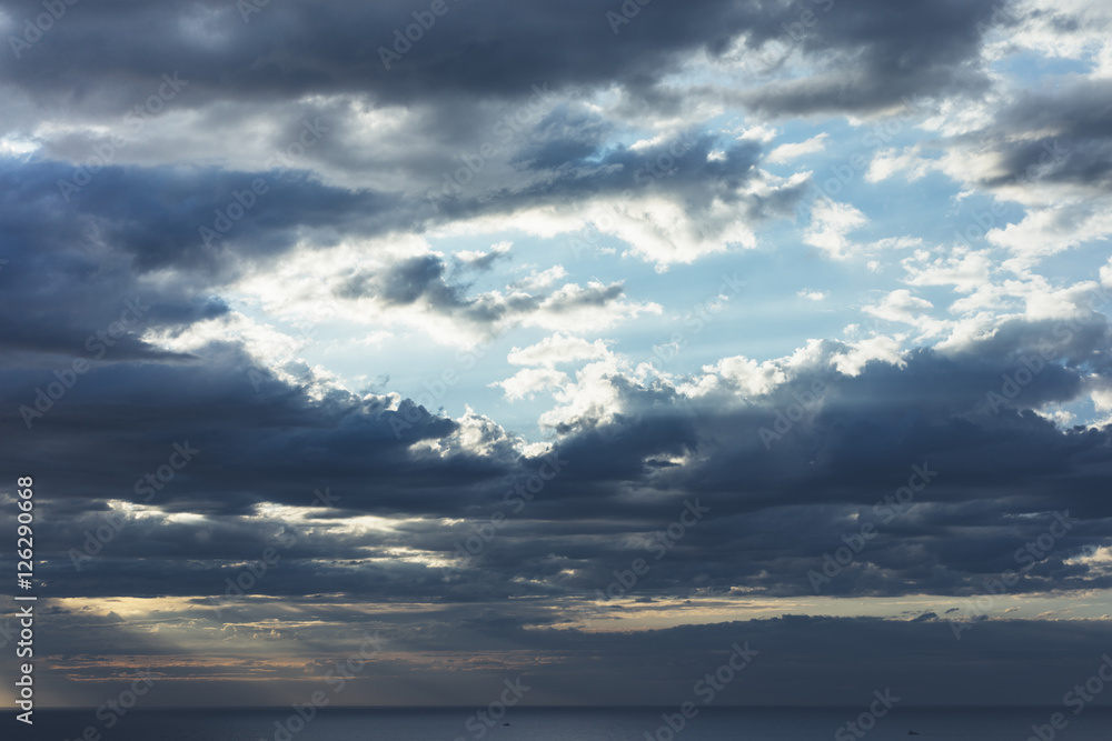 Clouds blue sky and sunlight sunset on horizon ocean. Сloudscape on background seascape dramatic atmosphere rays sunrise. Relax view waves sea, mockup nature evening concept.