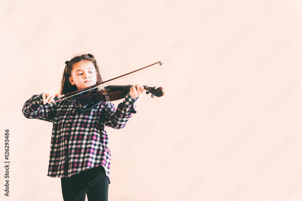 Mixed race female kid playing violin, child education or music concept, with copy space Mixed race female kid playing violin, child education or music concept, with copy space