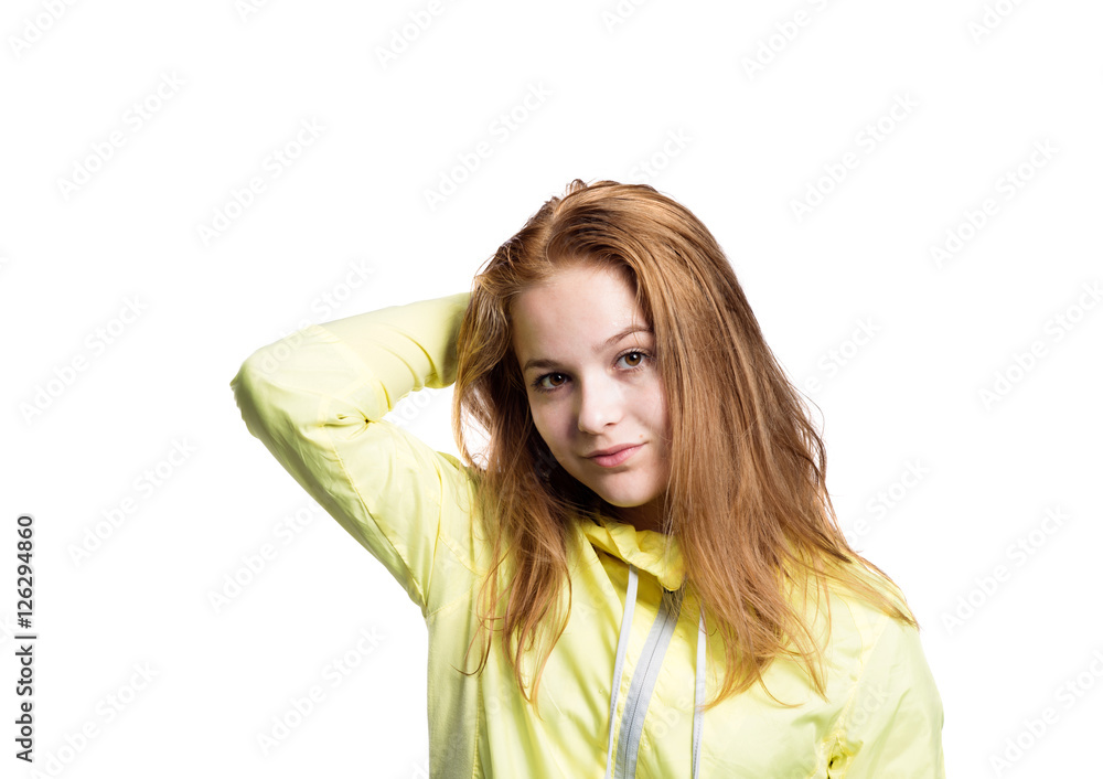 Teenage girl in yellow running jacket. Studio shot, isolated. Teenage girl in yellow running jacket. Studio shot, isolated.