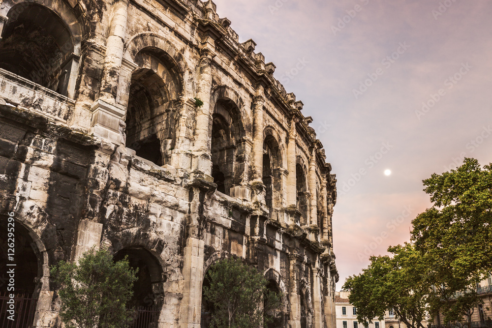 Arena of Nimes at sunrise and moonset