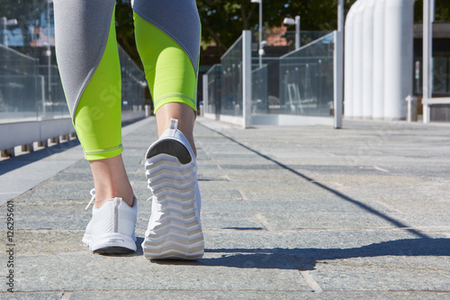 Woman ready to run outdoor in a modern city in a sunny day