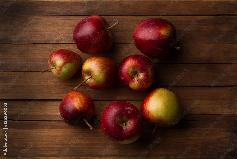 Organic small garden ripe apples on wooden plank Organic small garden ripe apples on wooden plank