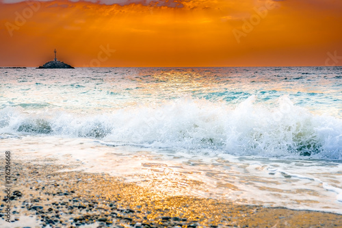 Waves that break down the Greek coast when the sun goes down photo