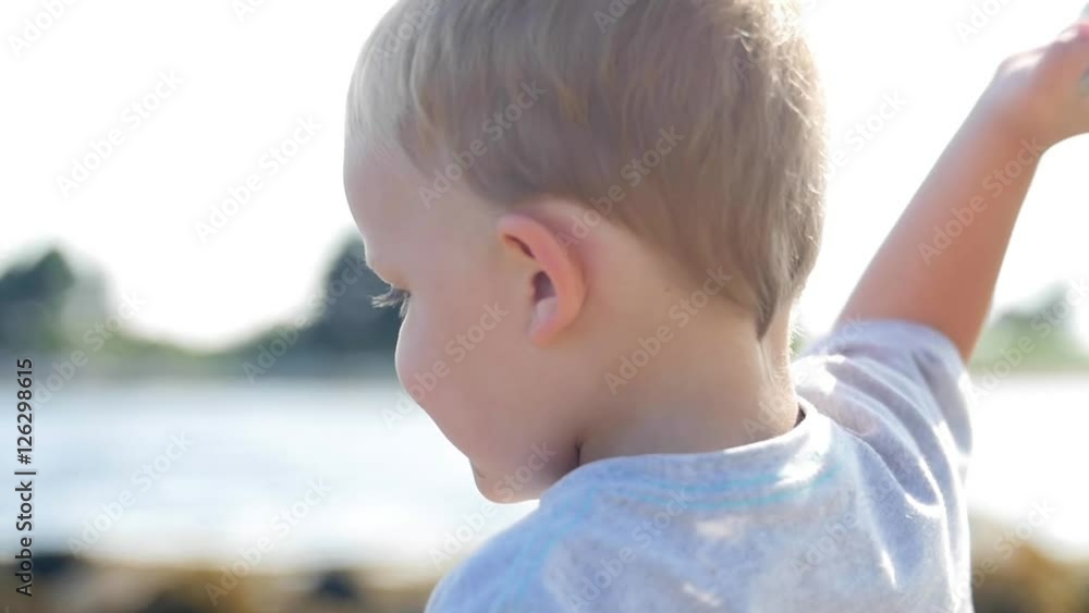 Boy throws rock into the ocean slow motion Boy throws rock into the ocean slow motion