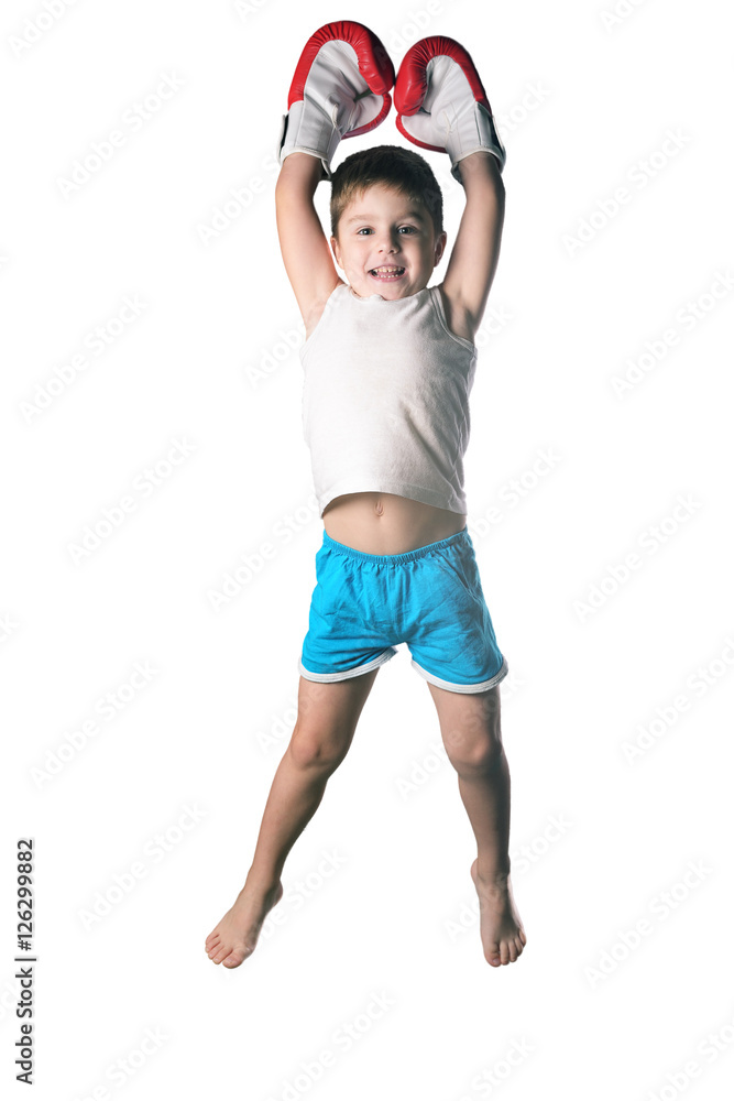 Little boy with red boxing gloves victory jump on white background isolated