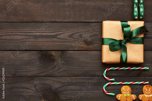 Christmas present and decoration on wooden background