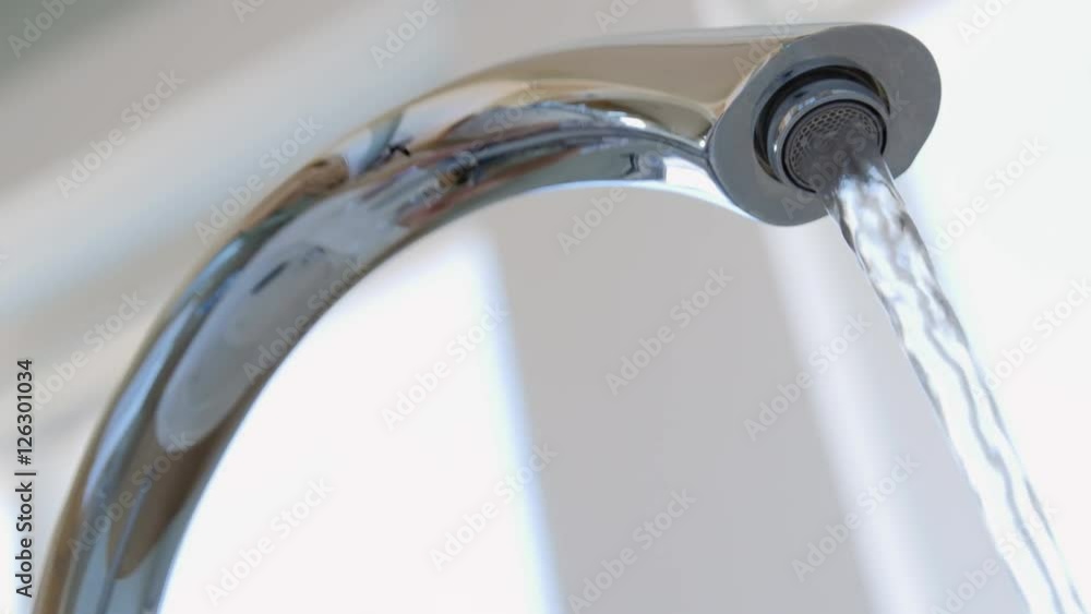 A low shot man turns on and off hot water in bath tub A low shot man turns on and off hot water in bath tub