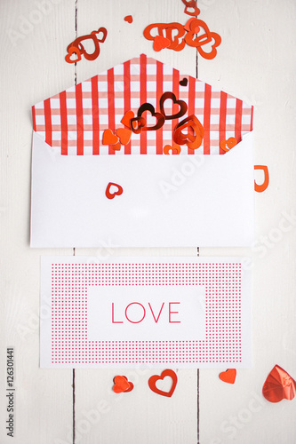 Envelope with paper hearts and postcard with love title