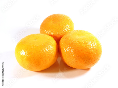 Close-up of three ripe oranges isolated on white background 
