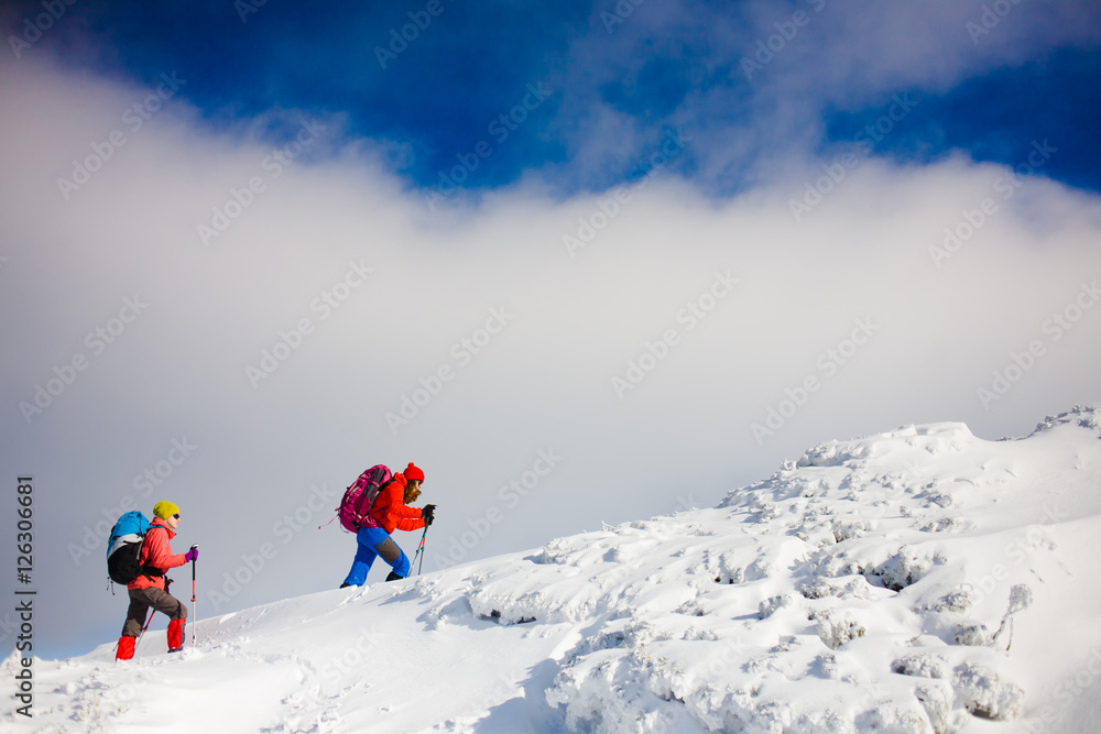 Climbers are on snow slope.