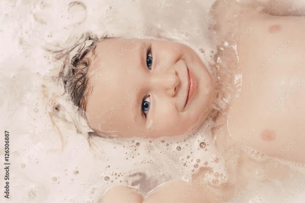 Little girl lying in the bathtub Little girl lying in the bathtub