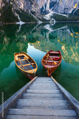 Boats on the Braies Lake ( Pragser Wildsee ) in Dolomites mounta