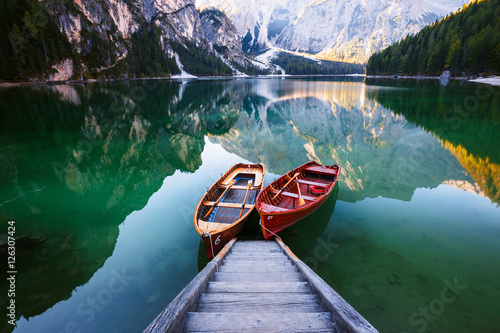 Boats on the Braies Lake ( Pragser Wildsee ) in Dolomites mounta