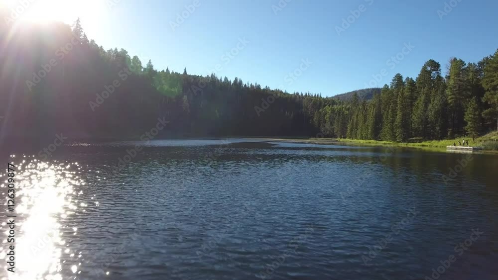 Aerial shot of fishing on beautiful mountain lake at sunset Aerial shot of fishing on beautiful mountain lake at sunset