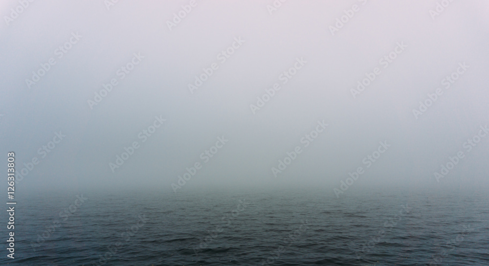 Fog over the water of the lake in autumn day. Abstract background image Fog over the water of the lake in autumn day. Abstract background image