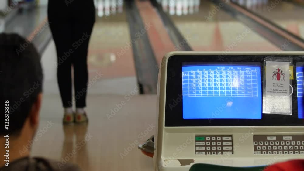 Young family bowls in small town bowling alley Young family bowls in small town bowling alley