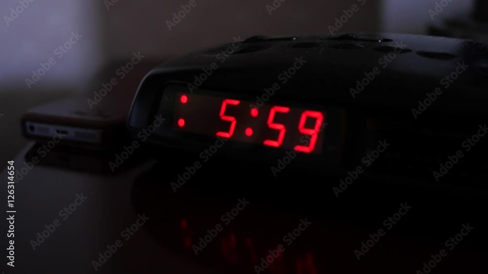 A digital alarm clock turns to six