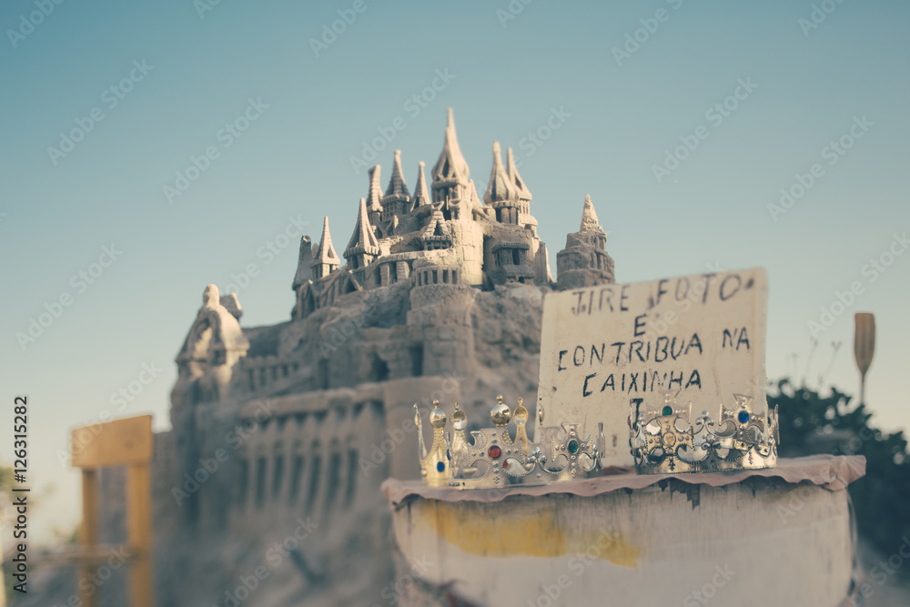 True tilt shift shooting of sand castle and crowns on beach of Rio de Janeiro, bright sunny day with clean sky, Brazil