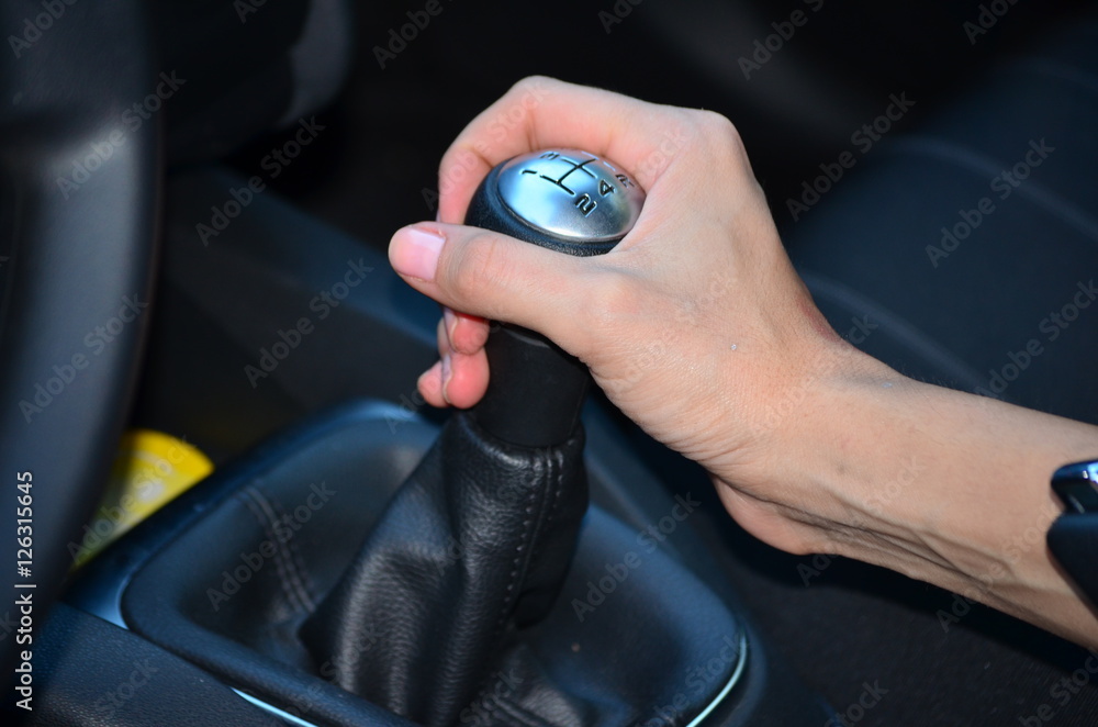 woman hand on manual gear shift knob