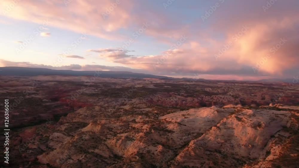 An aerial panning shot of beautiful desert cliffs and sunset landscape An aerial panning shot of beautiful desert cliffs and sunset landscape