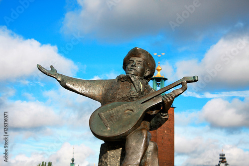 Evert Taubes monument and Stockholm city hall in summer photo