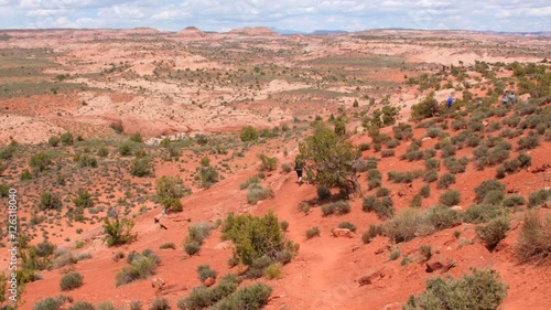 People hiking through hot desert in Utah photo