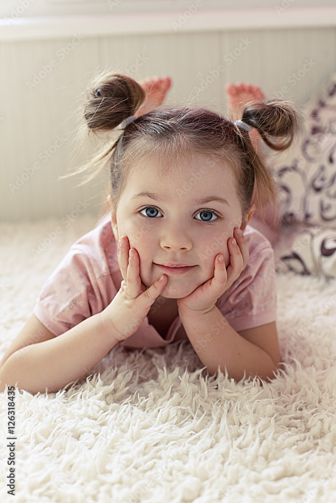 Fototapeta premium little girl lying on the sofa