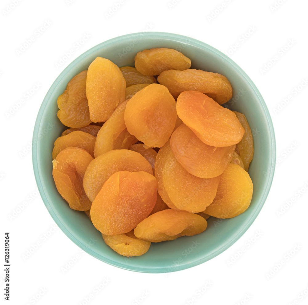 Dried apricots in a green bowl top view isolated on a white background. Dried apricots in a green bowl top view isolated on a white background.