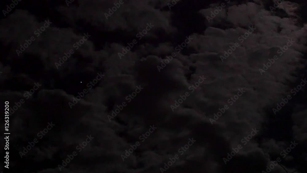 Clouds floating in the moonlight in the night sky Clouds floating in the moonlight in the night sky