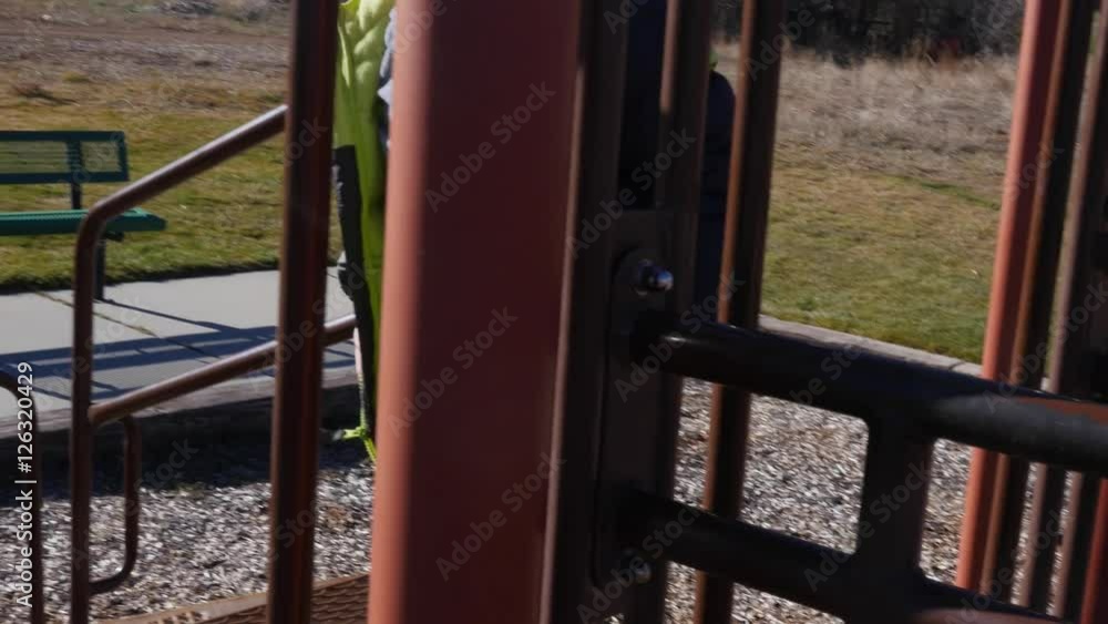 A boy plays on playground with slides and toys A boy plays on playground with slides and toys