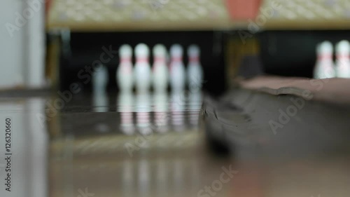 Bowling ball hits pins in bowling alley
