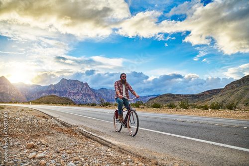 riding bike in nevada desert highway at sunset