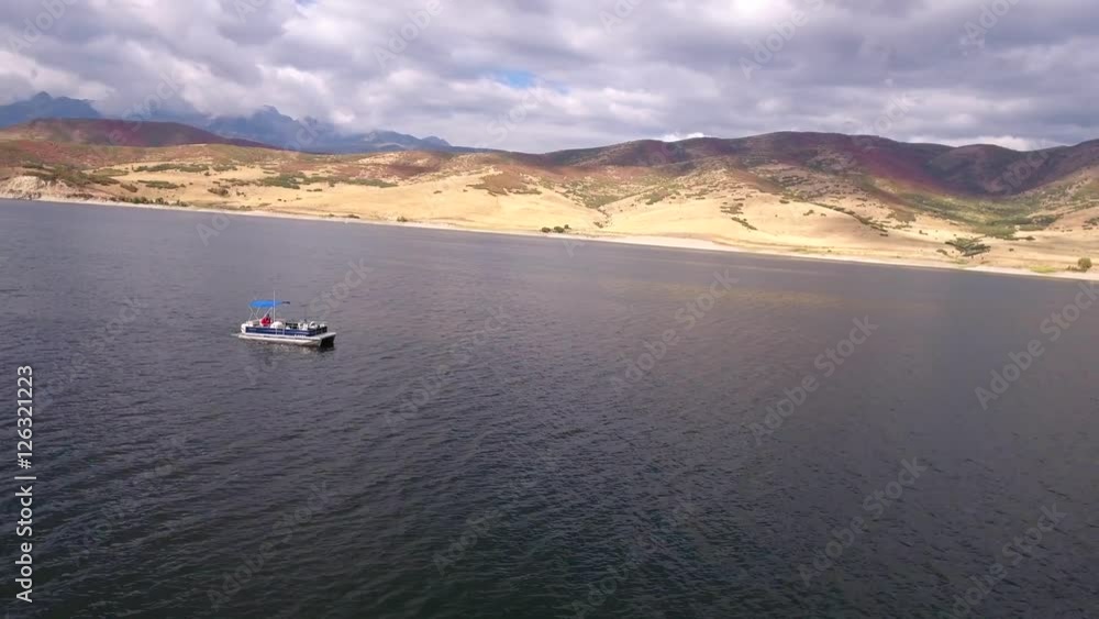Aerial shot of a boat traveling across lake Aerial shot of a boat traveling across lake