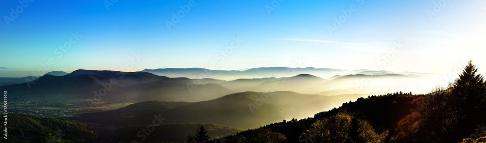 Aerial view of colorful autumnal mountains, foggy sunset