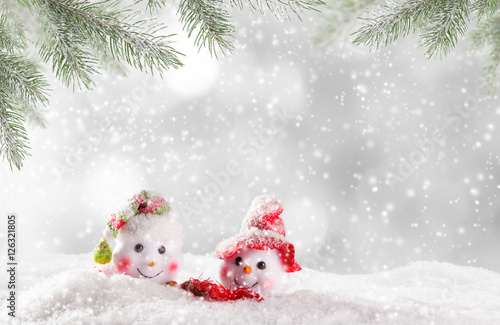 Christmas snowmen on abstract background