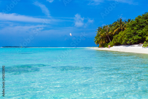 Fototapeta Naklejka Na Ścianę i Meble -  Palm trees leaning over sand beach, Maldives