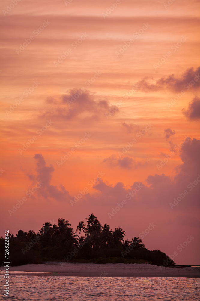 Romantic orange sunset with tropical island, Maldives
