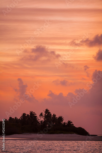 Romantic orange sunset with tropical island  Maldives