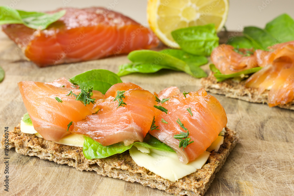 Sandwich with salted marinated salmon on wooden background Sandwich with salted marinated salmon on wooden background