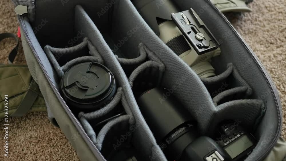 Timelapse man puts camera gear into pack Timelapse man puts camera gear into pack