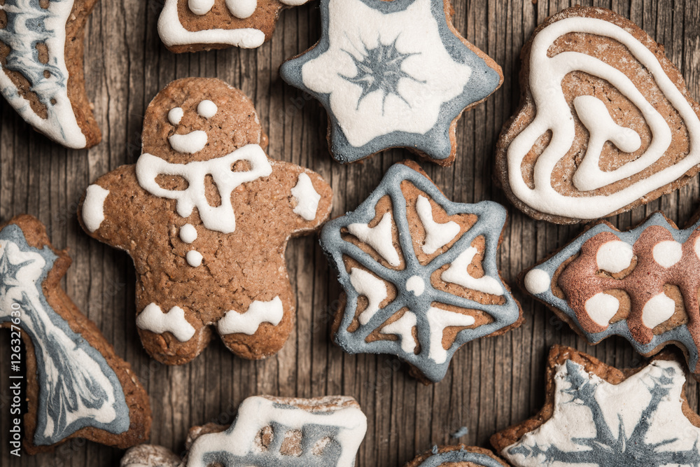 Colorfully Christmas cookies on rustic wooden background, gingerman and tree