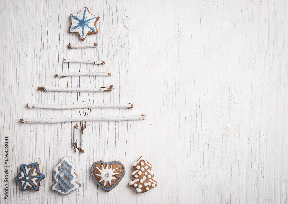 Christmas tree made of branches and gingerbread cookie as background Christmas tree made of branches and gingerbread cookie as background