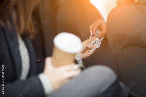 Female passenger in taxi paying the driver for trip