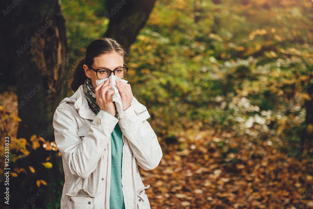 Woman blowing her nose
